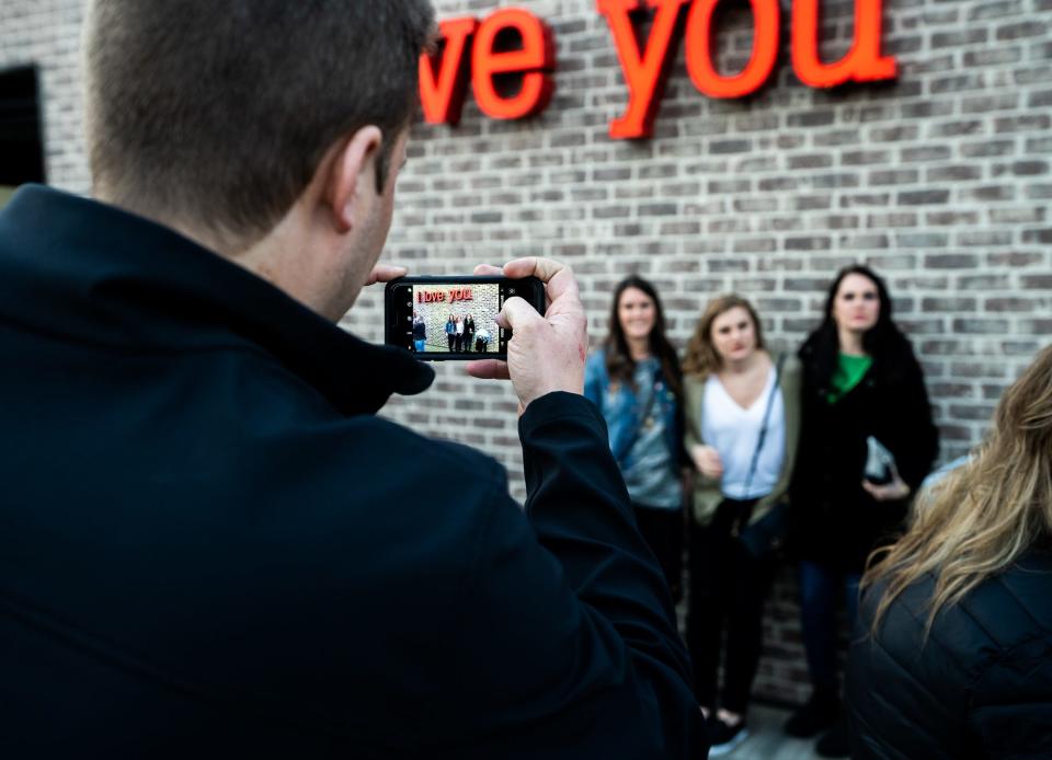 A photo Pave shared on their business Instagram page encourages customers to take photos in front of the neon "I love you" sign on the bar's patio.