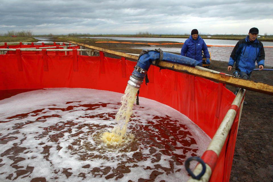 Image: Employees of Russia's state-owned oil pipeline monopoly Transneft during a clean-up operation following a massive fuel spill in the Ambarnaya River outside Norilsk on June 10, 2020. (Irina Yarinskaya  / AFP via Getty Images)