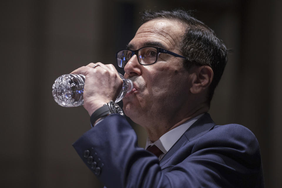 Treasury Secretary Steven Mnuchin drinks water as he arrives to testify during a House Financial Services Committee hearing on the coronavirus response on Capitol Hill in Washington, Tuesday, June 30, 2020. (Tasos Katopodis/Pool via AP)