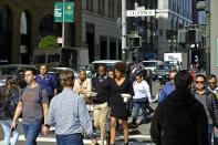 People make their way through the Financial District across California Street Friday, Oct. 18, 2019, in San Francisco. California's unemployment rate fell to a new record low of 4% in September. The state Employment Development Department says Friday that employers added 21,300 nonfarm payroll jobs, extending California's record job expansion to 115 months. (AP Photo/Eric Risberg)