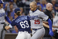 Los Angeles Dodgers' Trayce Thompson (25) avoids Kansas City Royals relief pitcher Josh Staumont (63) near home plate as he scores off a single by Trea Turner during the seventh inning of a baseball game in Kansas City, Mo., Friday, Aug. 12, 2022. (AP Photo/Colin E. Braley)