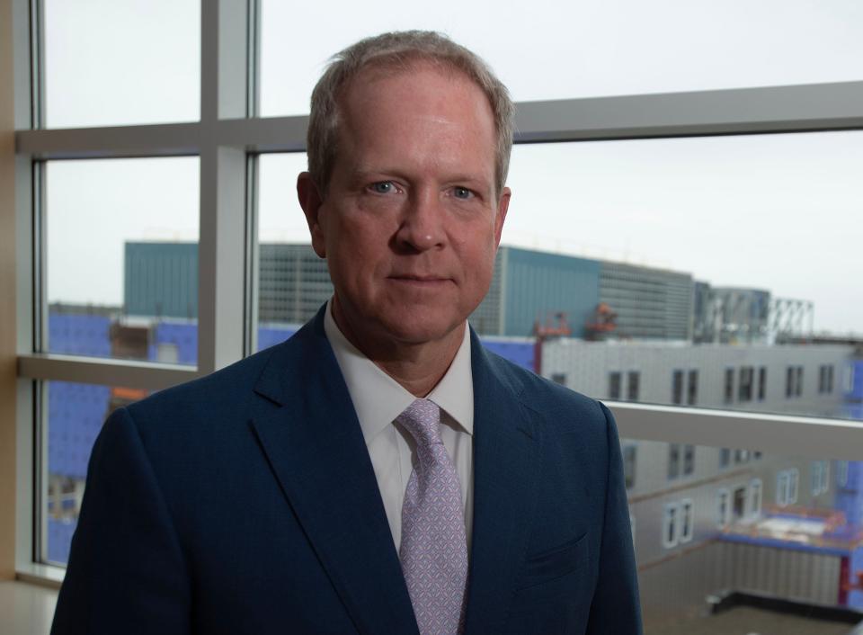 Cape Cod Healthcare CEO Mike Lauf photographed on the sixth floor of Cape Cod Hospital where the new Barbey Patient Care Tower rises up behind him in Hyannis.