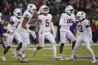 Washington State defensive back Derrick Langford (5) celebrates with teammates after he intercepted a pass against Washington during the second half of an NCAA college football game, Friday, Nov. 26, 2021, in Seattle. (AP Photo/Ted S. Warren)