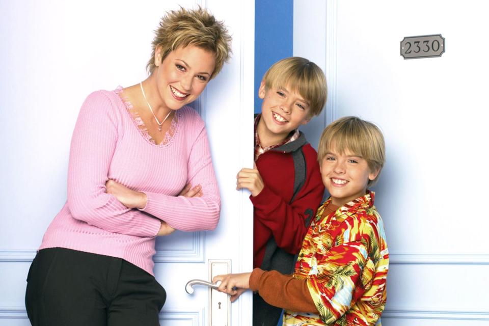 <p>Disney Channel / Courtesy Everett</p> Kim Rhodes, Dylan and Cole Sprouse pose for season 1 of Disney Channel
