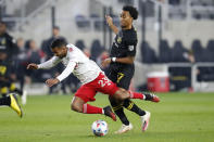 New York Red Bulls' Cristian Casseres, left, and Columbus Crew's Marlon Hairston collide during the first half of an MLS soccer match Saturday, Oct. 23, 2021, in Columbus, Ohio. (AP Photo/Jay LaPrete)