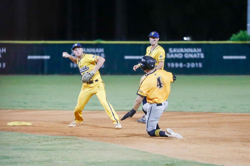 Savannah Bananas shortstop Jack Renwick turns the double play and throws to first base for the final out of Game 2 as the Wilson Tobs' Harrison Pontoli slides into second base on Friday, Aug. 5, 2022, at Grayson Stadium. The Bananas won 11-0 to sweep the Petitt Cup championship series.