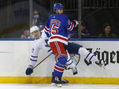 New York Rangers' Braden Schneider (45) checks Toronto Maple Leafs' Pierre Engvall (47) during the first period of an NHL hockey game Wednesday, Jan. 19, 2022, in New York. (AP Photo/John Munson)