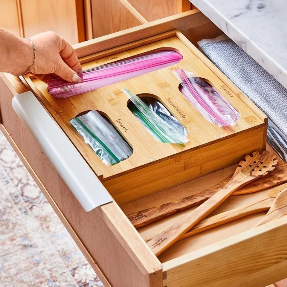 model pulling bag from organizer in drawer