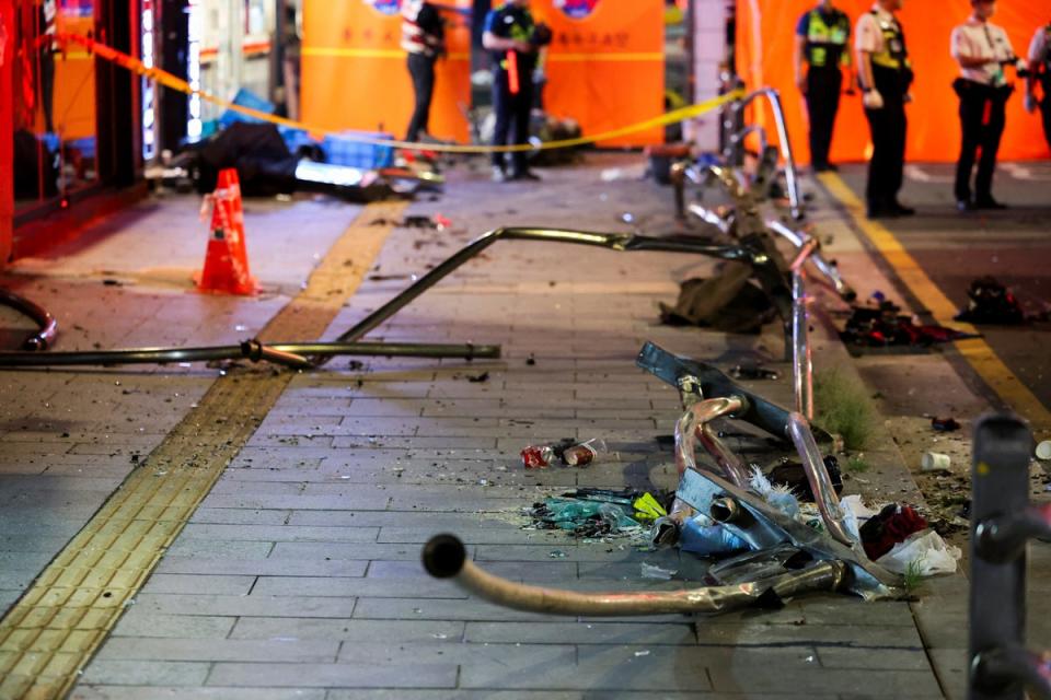 Broken glass and debris lie at the scene of car accident that resulted in several people killed and injured in central Seoul (REUTERS)