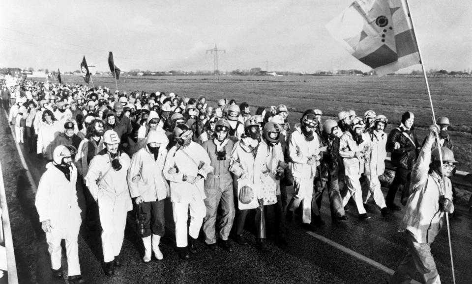 FILE - Protesters march near the construction site of a nuclear power plant in Brokdorf, Germany, on April 1, 1977. Germany is shutting down its last three nuclear power plants on Saturday, April 15, 2023, as part of an energy transition agreed by successive governments. The final countdown, delayed for several months over feared energy shortages because of the Ukraine war, is seen with relief by Germans who have campaigned against nuclear power. (AP Photo, File)