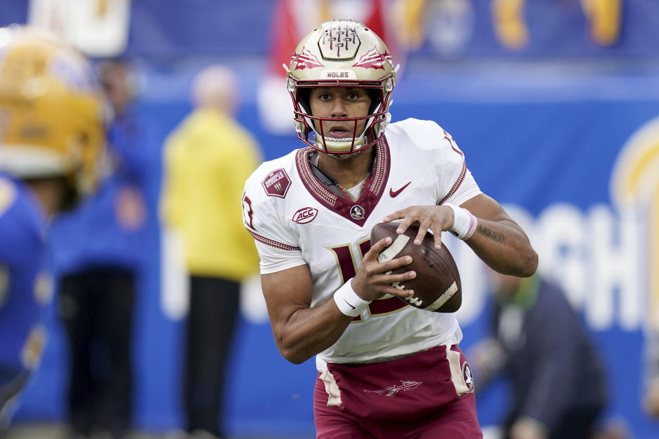 Florida State quarterback Jordan Travis (13) looks to throw a pass during the first half of an NCAA college football game against Pittsburgh in Pittsburgh, Saturday, Nov. 4, 2023. (AP Photo/Matt Freed)