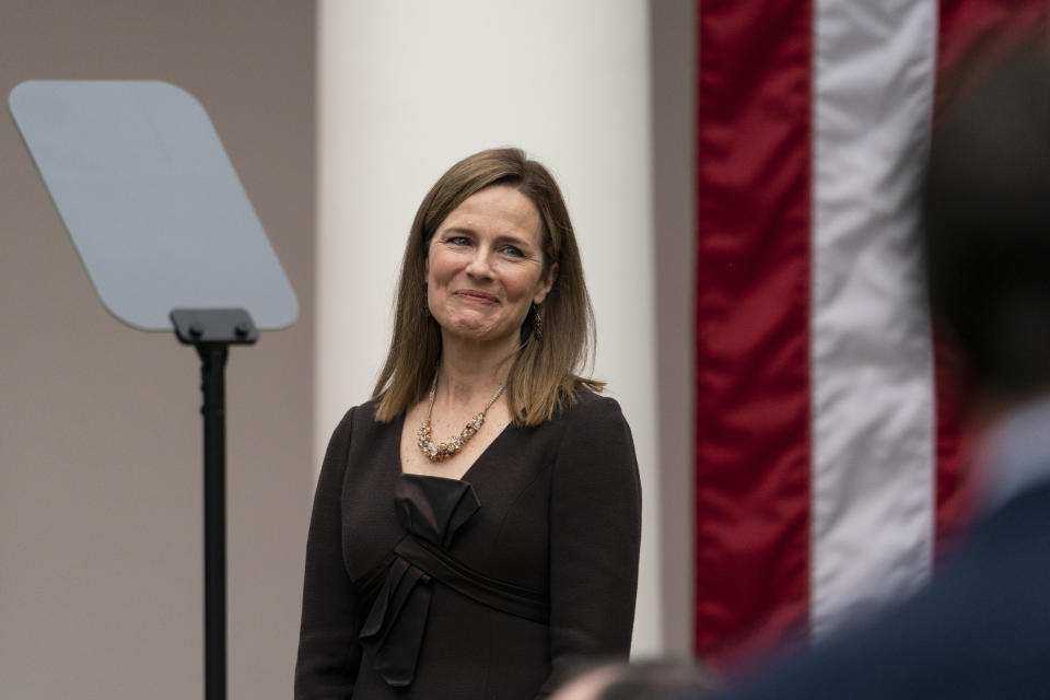 Judge Amy Coney Barrett smiles as President Donald Trump announces her as his nominee to the Supreme Court, in the Rose Garden at the White House, Saturday, Sept. 26, 2020, in Washington. (AP Photo/Alex Brandon)
