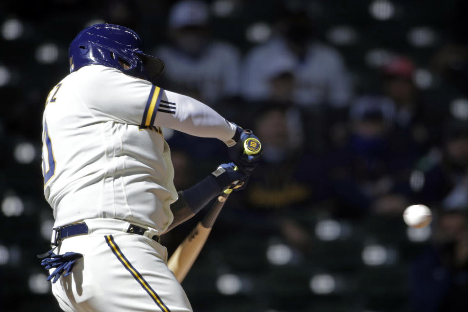 Milwaukee Brewers' Omar Narvaez hits an RBI single during the fifth inning of an Opening Day baseball game against the Minnesota Twins Thursday, April 1, 2021, in Milwaukee. (AP Photo/Aaron Gash)