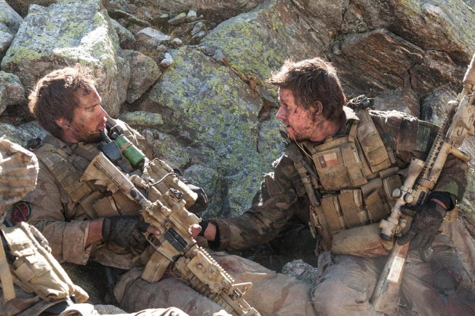 FILE - This file photo released by Universal Pictures shows Taylor Kitsch, left, as Michael Murphy and Mark Wahlberg as Marcus Luttrell in a scene from the film, “Lone Survivor." The Navy SEAL drama earned $37.8 million in its first weekend of wide release. (AP Photo/Universal Pictures, Gregory R. Peters, File)