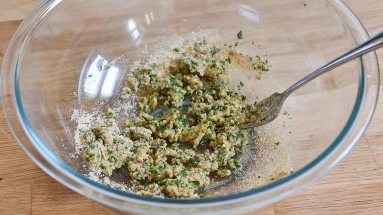 stirring egg into breadcrumb mix