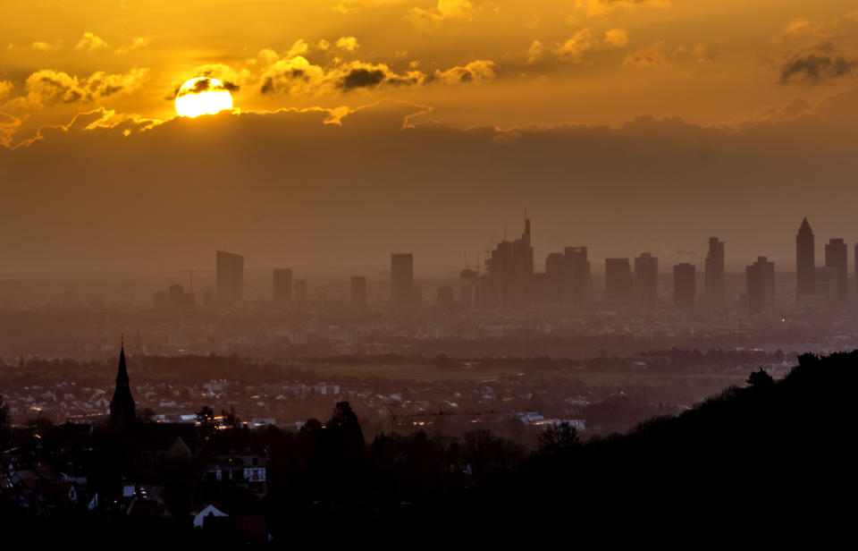 The sun rises over the buildings of the banking district in Frankfurt, Germany, Wednesday, Feb. 1, 2023. (AP Photo/Michael Probst)
