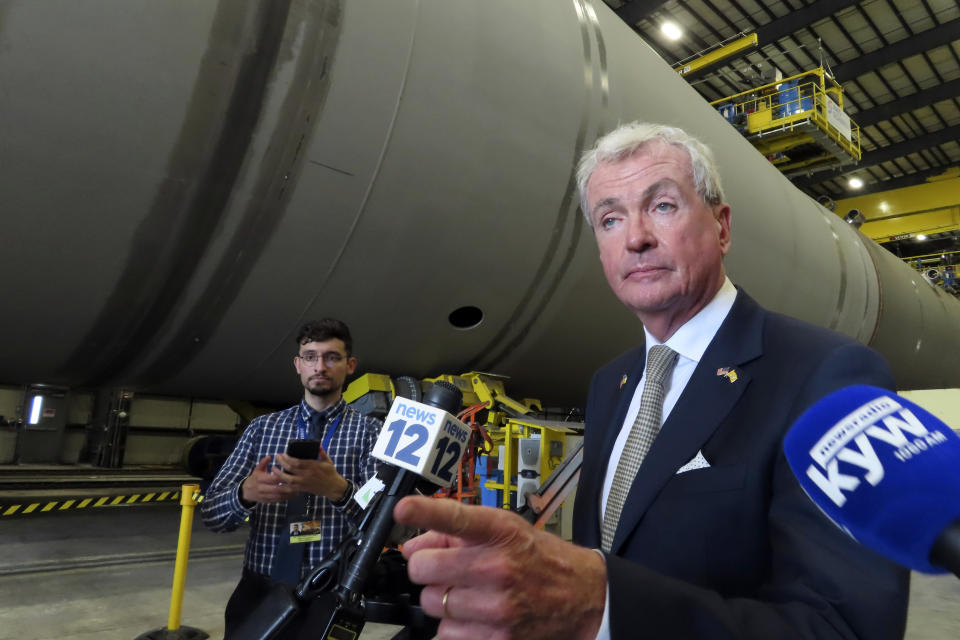 New Jersey Gov. Phil Murphy speaks to reporters after signing a bill in Paulsboro, N.J., Thursday, July 6, 2023, granting a tax break to offshore wind energy developer Orsted. (AP Photo/Wayne Parry)