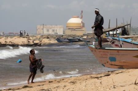 A fisherman stands on his boat on a beach near Kudankulam nuclear power project in the southern Indian state of Tamil Nadu, India, September 13, 2012. REUTERS/Adnan Abidi/File Photo