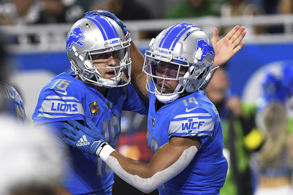 Detroit Lions wide receiver Amon-Ra St. Brown (14) celebrates his four-yard touchdown reception with Jared Goff (16) in the second half of an NFL football game against the Philadelphia Eagles in Detroit, Sunday, Sept. 11, 2022. (AP Photo/Lon Horwedel)