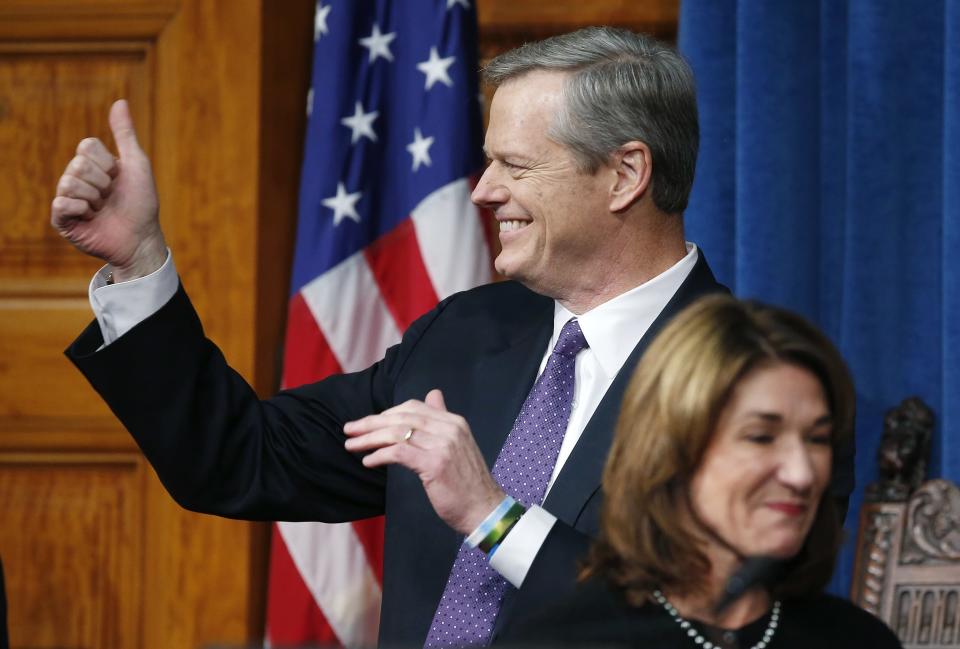 FILE — Massachusetts Gov. Charlie Baker gives a thumbs-up behind Lt. Gov. Karyn Polito during inauguration ceremonies, Thursday, Jan. 3, 2019, at the Statehouse in Boston. Baker announced Wednesday, Dec. 1, 2021 that he won't seek a third term as governor of Massachusetts. (AP Photo/Michael Dwyer, File)