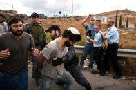 Israeli settlers are prevented by police from entering the Palestinian town of Beit Sahour in the West Bank on October 7, 2015 during a protest against the rise in attacks on settler cars by stone throwers