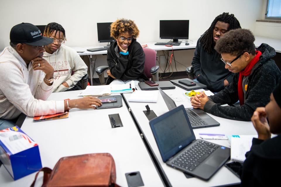 Austin-East Magnet High students participating in the University of Tennessee's Project Excellence program inquire about a musical artist participating in the Healthy for the Holidays event they are helping plan.