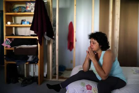 Immigrant Rosa Sabido, 53, cries as she sits on her bed in the United Methodist Church in which she lives while facing deportation in Mancos, Colorado, U.S., July 19, 2017. REUTERS/Lucy Nicholson/Files