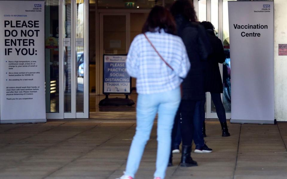 People queue outside the vaccination centre at the Madejski Stadium in Reading, Berkshire, before receiving the Moderna Covid-19 vaccine.  - Steve Parsons/PA Wire