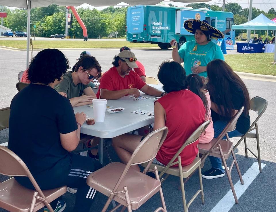 Daniela Garcia leads Latino bingo for a group of festival goers at Northeast Alabama Community College's Latino Festival on June 10, 2023.