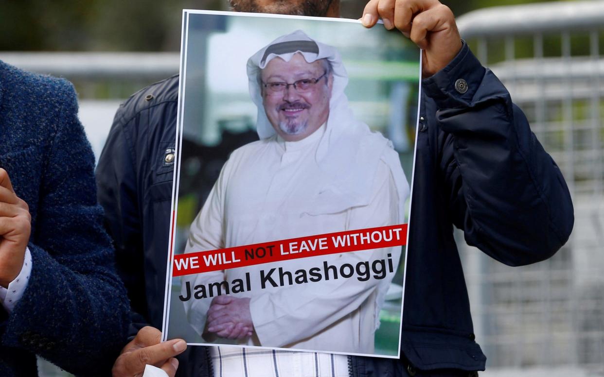 A demonstrator holds picture of Saudi journalist Jamal Khashoggi during a protest in front of Saudi Arabia's consulate in Istanbul - REUTERS