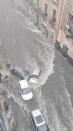 Flood sweeps through a street in the Sicilian city of Catania