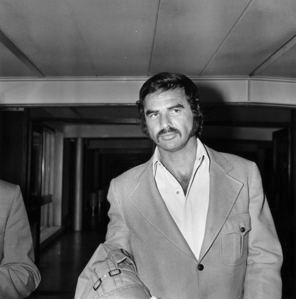 <p>Here he heads to his plane at the Los Angeles airport in 1973 in an open button-down and double-breasted suit.</p>