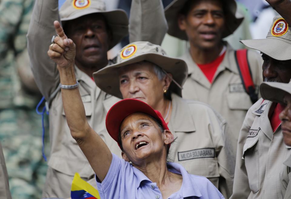 Supporters of President Nicolas Maduro sing a song about Venezuela's late president Hugo Chavez, during a event at Bolivar Square in Caracas, Venezuela, Thursday, Feb. 7, 2019. Maduro said that he hopes to collect 10 million signatures to ask Washington to withdraw its threats of war against the people of Venezuela. (AP Photo/Ariana Cubillos)