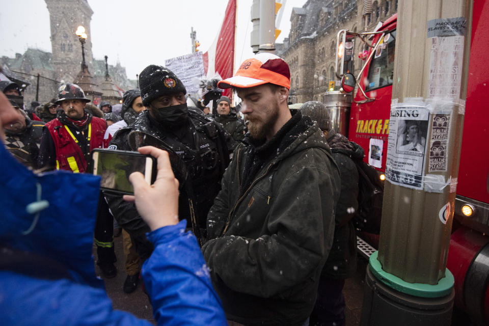 Police arrest a protester on Wellington Street, during an ongoing protest against COVID-19 measures that has grown into a broader anti-government protest, in Ottawa, Ontario, on Thursday, Feb. 17, 2022. (Justin Tang/The Canadian Press via AP)