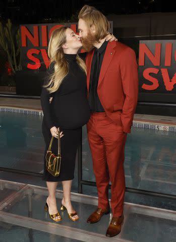 <p>Frazer Harrison/Getty Images</p> Meredith Hagner and Wyatt Russell share a kiss at the Los Angeles premiere of 'Night Swim'