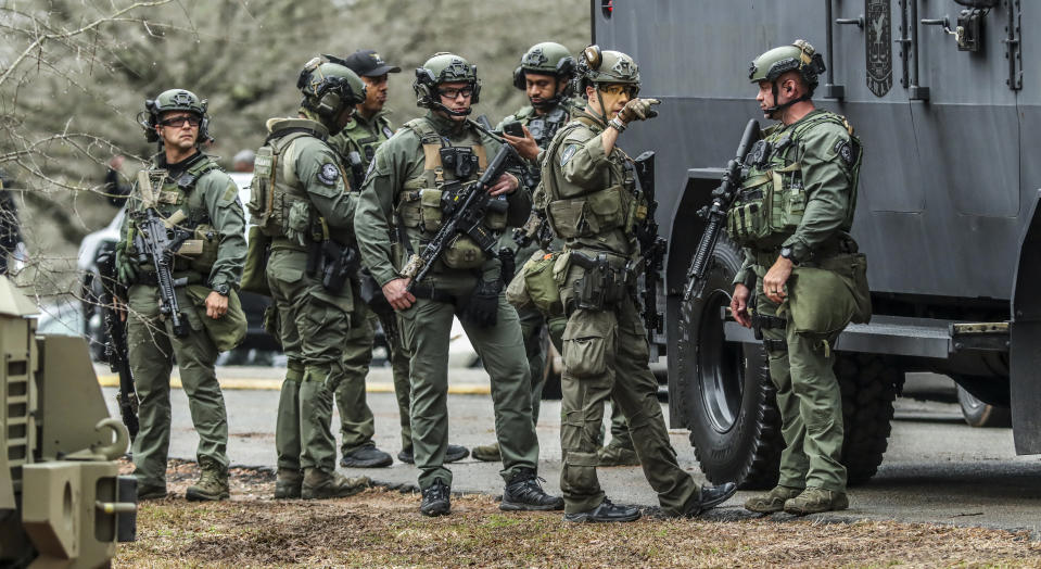 DeKalb, Ga., and Atlanta SWAT members are pictured leaving the Gresham Park command post in Atlanta on Wednesday, Jan. 18, 2023. Georgia state troopers helping conduct a "clearing operation" at the site of Atlanta's planned public safety training center exchanged gunfire with a protester Wednesday morning, leaving the protester dead and one trooper wounded, according to the Georgia Bureau of Investigation. (John Spink/Atlanta Journal-Constitution via AP)