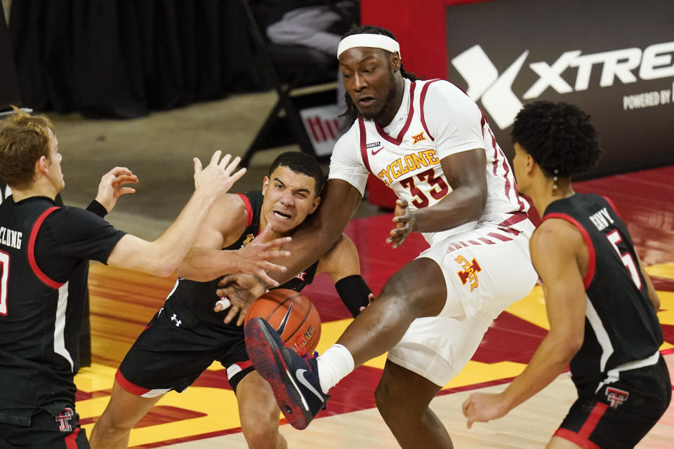 Texas Tech guard Kevin McCullar fights for a rebound with Iowa State forward Solomon Young (33) during the first half of an NCAA college basketball game, Saturday, Jan. 9, 2021, in Ames, Iowa. (AP Photo/Charlie Neibergall)