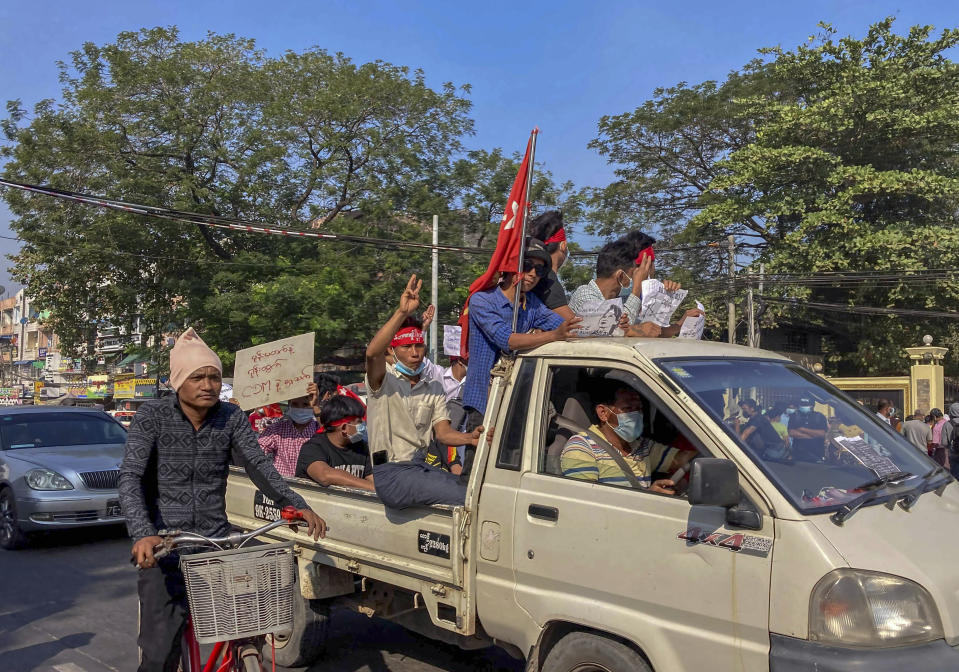 Demonstrators flash three-fingered salute, a symbol of resistance against the military coup in Yangon, Myanmar Thursday, Feb. 12, 2021. Large crowds demonstrating against the military takeover in Myanmar again defied a ban on protests, even after security forces ratcheted up the use of force against them. (AP Photo)