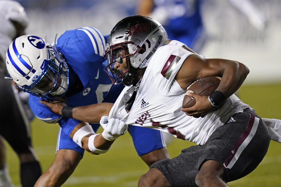 BYU defensive back Troy Warner (4) tackles Troy wide receiver Kaylon Geiger (1) during the second half of an NCAA college football game Saturday, Sept. 26, 2020, in Provo, Utah. (AP Photo/Rick Bowmer, Pool)