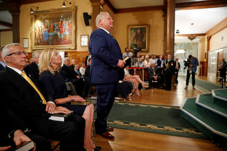 Doug Ford (R) is sworn in as premier of Ontario with his cabinet ministers Christine Elliott and Vic Fedeli during a ceremony at Queen's Park in Toronto on Friday, June 29, 2018. Mark Blinch/Pool via REUTERS