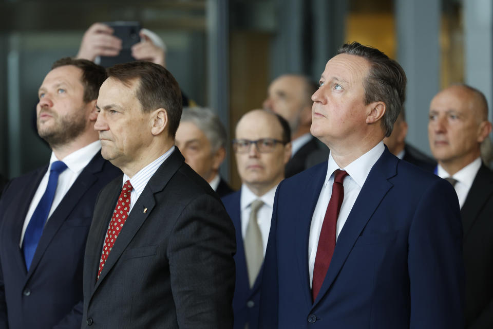 British Foreign Secretary David Cameron, second right, and Poland's Foreign Minister Radoslaw Sikorski, second left, attend a ceremony to mark the 75th anniversary of NATO at NATO headquarters in Brussels, Thursday, April 4, 2024. NATO marked on Thursday 75 years of collective defense across Europe and North America, with its top diplomats vowing to stay the course in Ukraine as better armed Russian troops assert control on the battlefield. (AP Photo/Geert Vanden Wijngaert)