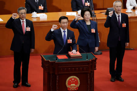 Newly elected Vice Premiers (L-R) Hu Chunhua, Han Zheng, Sun Chunlan and Liu He take an oath to the constitution at the seventh plenary session of the National People's Congress (NPC) at the Great Hall of the People in Beijing, China March 19, 2018. REUTERS/Jason Lee