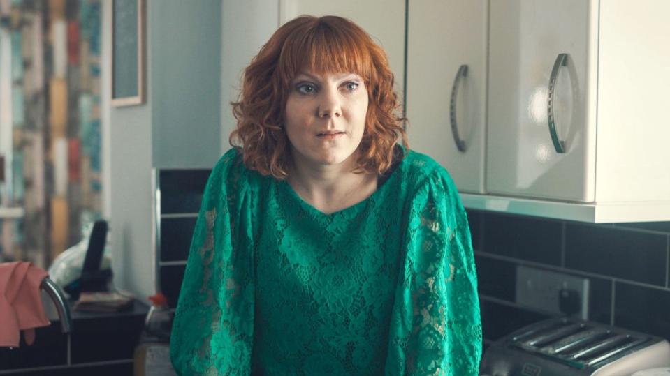 alma's not normal sophie willan in a kitchen wearing a green top