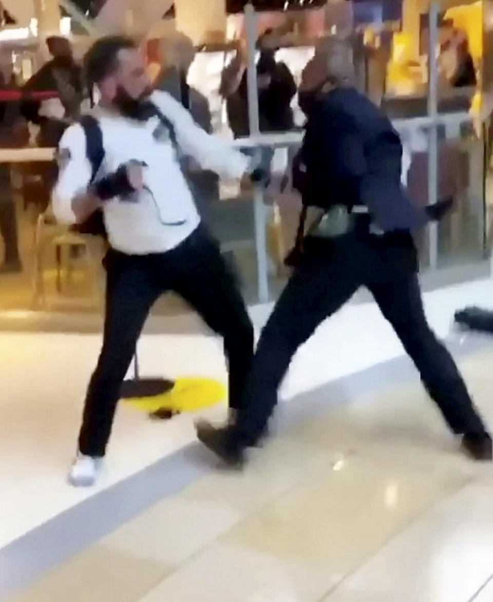 This is the shocking moment a security guard and a shopper viciously brawled outside a Selfridges following a row about entering the store with rollerblades. The smartly-dressed security worker traded punches with the irate customer after violence erupted at Birmingham's Bull Ring shopping centre on Saturday (26/9). The pair can be seen adopting boxing stances before exchanging blows in front of stunned shoppers at the entrance of the posh department store. In the footage, obtained by website Birmz Is Grime, one man can be heard saying "chill man" before the video ends with two burly men continuing to swing punches.