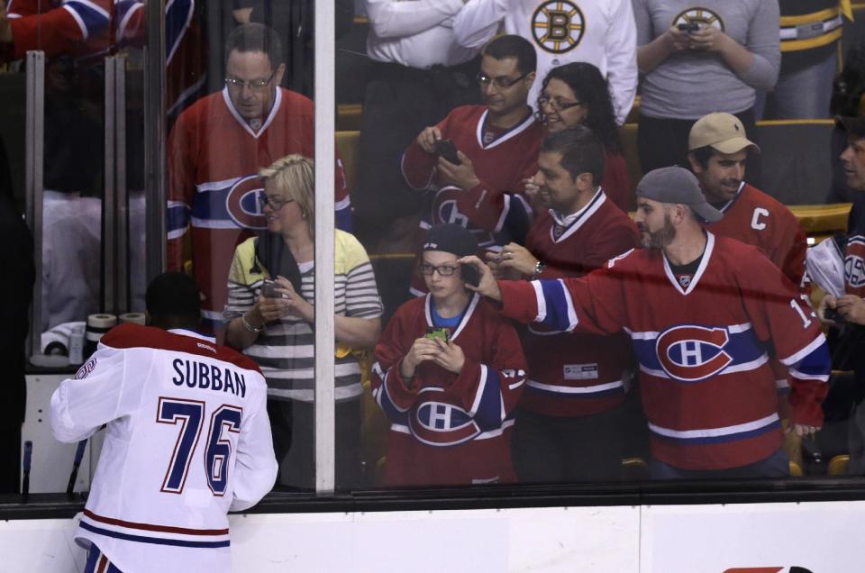 Montreal Canadiens fans photograph defenseman P.K. Subban (76) during a warmup before facing the Boston Bruins in Game 5 of the second-round of the Stanley Cup hockey playoff series in Boston, Saturday, May 10, 2014. (AP Photo/Charles Krupa)