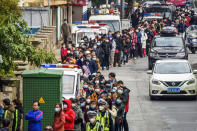 FIE - In this Jan. 29, 2020, file photo, people line up to buy face masks from a medical supply company in Nanning in southern China's Guangxi Zhuang Autonomous Region. Fear of the spreading coronavirus has led to a global run on sales of face masks despite medical experts' advice that most people who aren't sick don't need to wear them. (Chinatopix via AP, File)