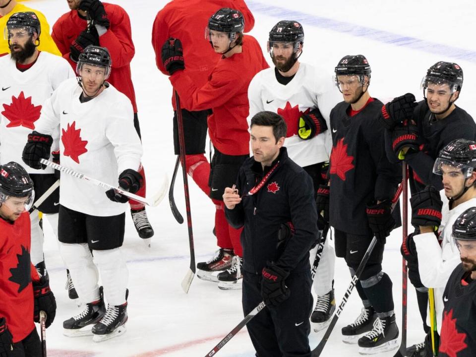 Team Canada, led by head coach Jeremy Colliton during practice on Saturday, hopes its blend of youth and experience will be a recipe for a gold medal in Beijing. (Paul Chiasson/The Canadian Press - image credit)