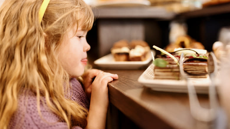 child looking at buffet food