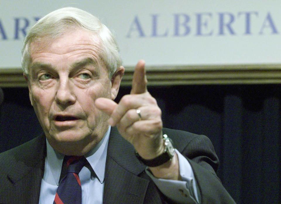Former Alberta premier Peter Lougheed gestures during a news conference in Calgary in 2002.