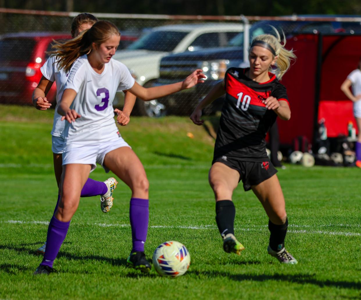 Onsted's Lexi Rankin and Clinton's Aubrey Lauer battle for possession during Thursday's game at Clinton.